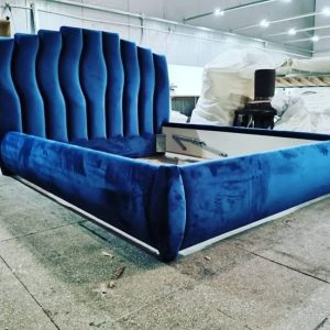 Royal blue upholstered bed with tall wavy headboard – ReNew Studio