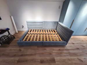 Upholstered bed with corner headboard – custom design by ReNew Studio