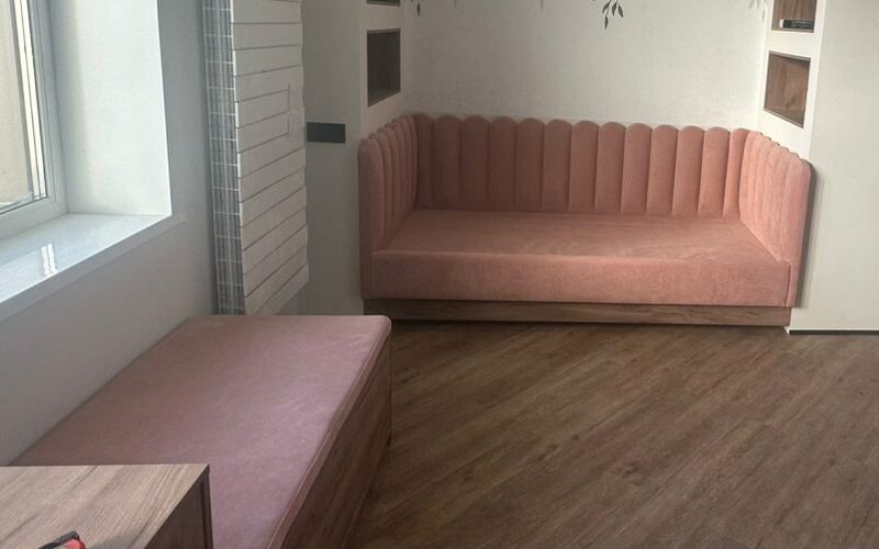 Pink upholstered bed with scalloped headboard – ReNew Studio